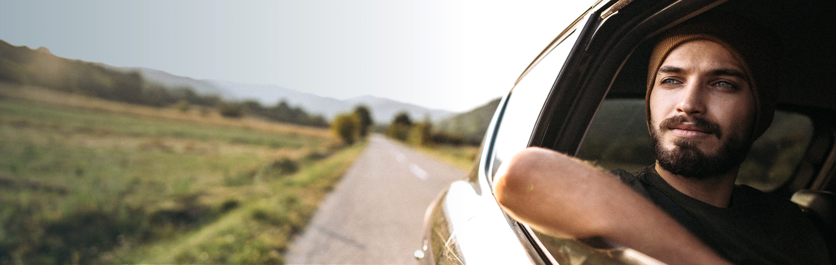 Hero-man-looking-to-horizon-inside-car