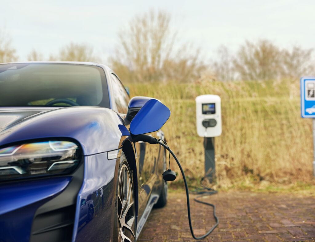 Blue car charging in public