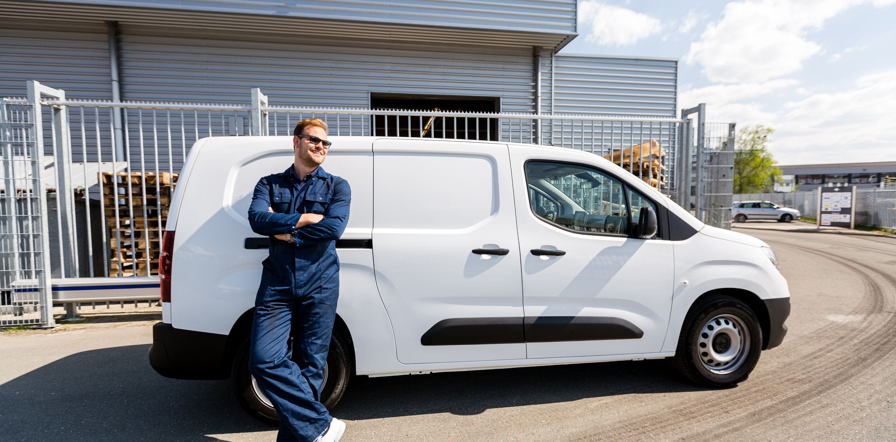 Man by a white van
